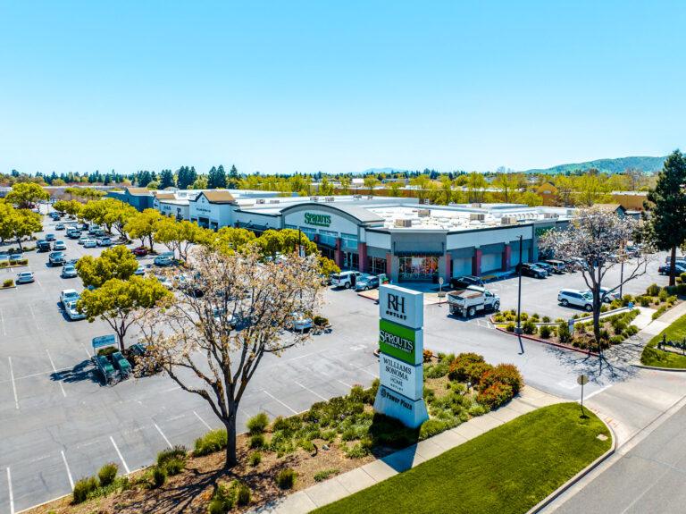 A parking lot with cars parked in it and trees