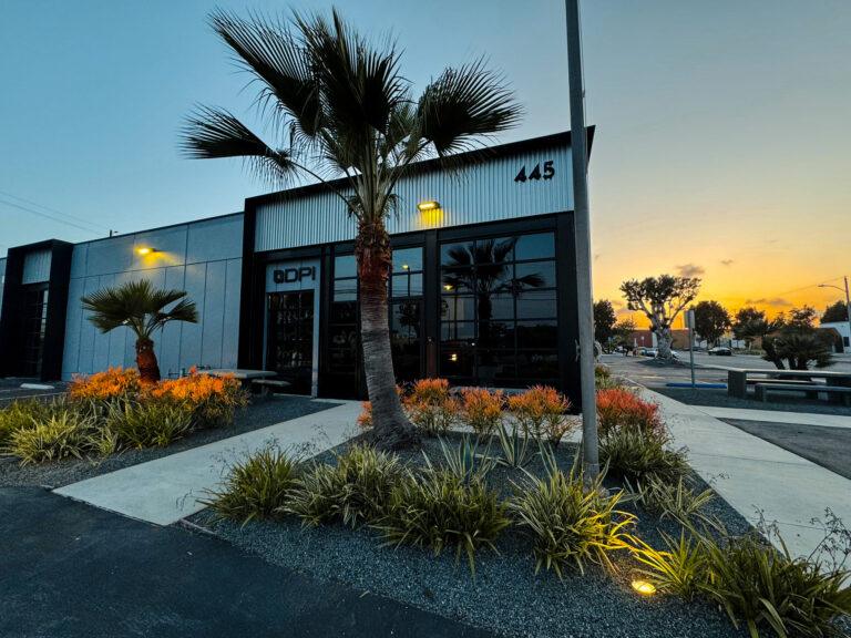 A building with a palm tree in the middle of it.