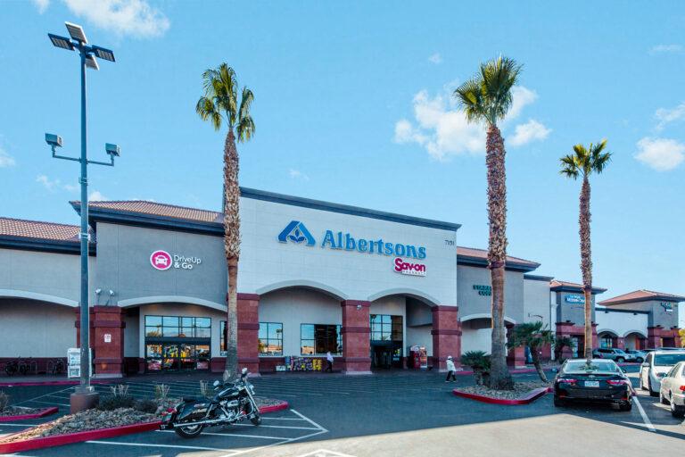 A large building with palm trees in front of it.