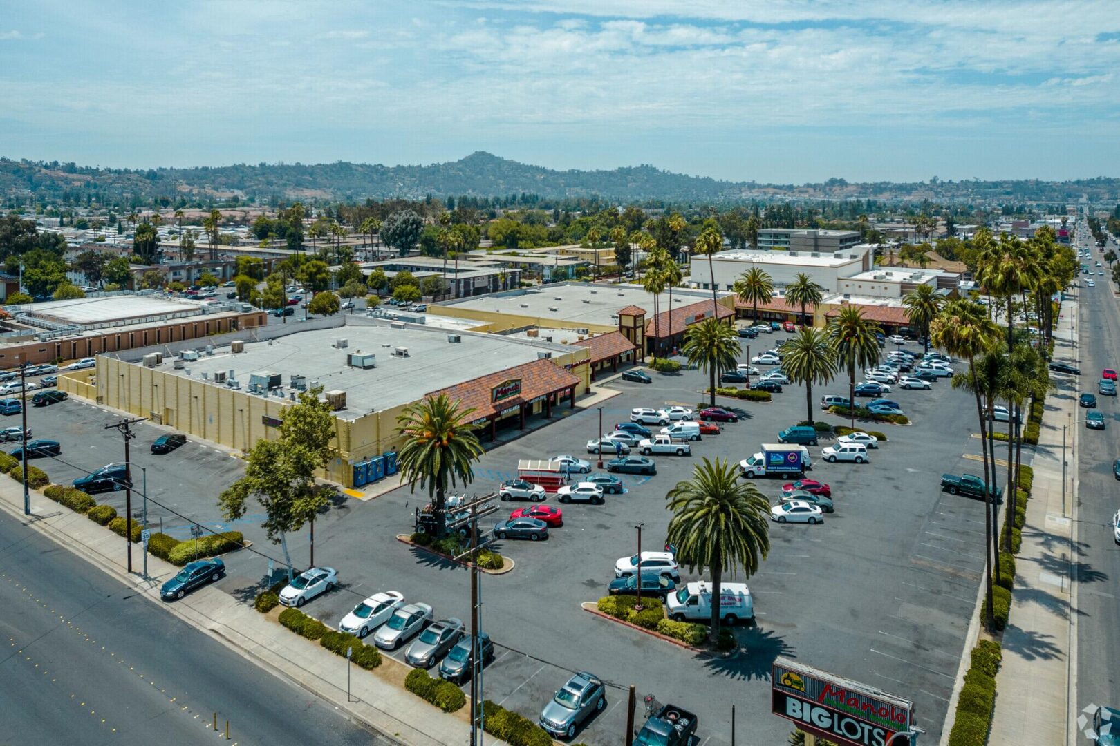 A parking lot with many cars parked in it