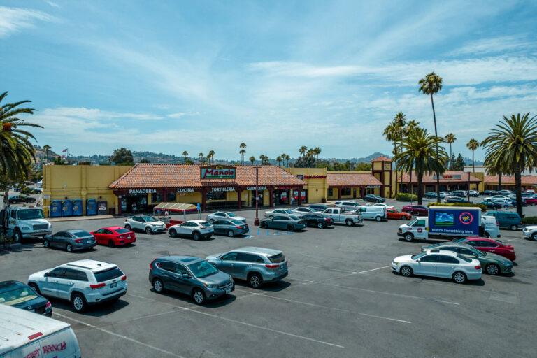 A parking lot with many cars parked in it