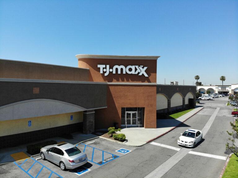 A large brick building with cars parked in front of it.