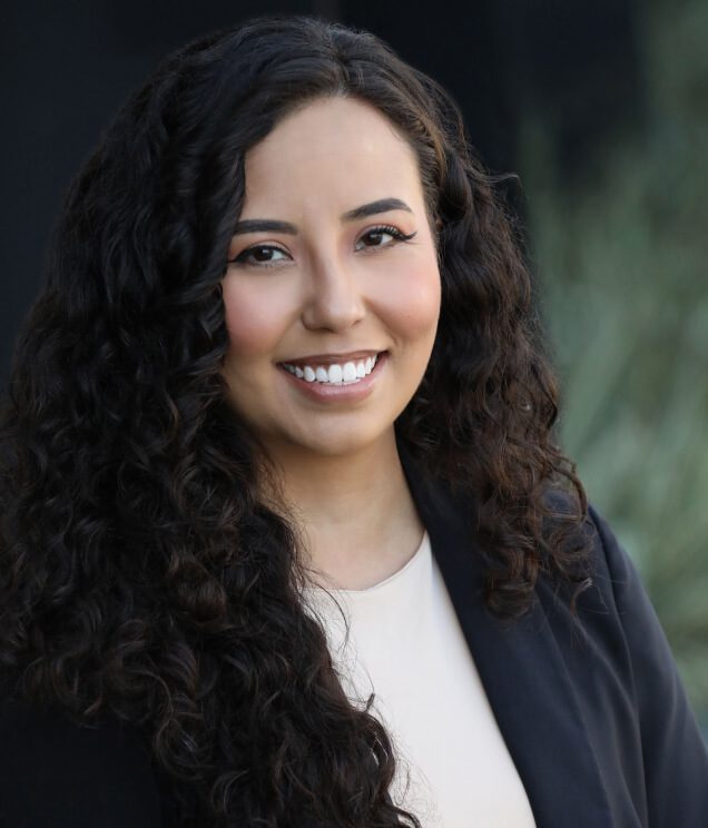 A woman with long hair and a smile.