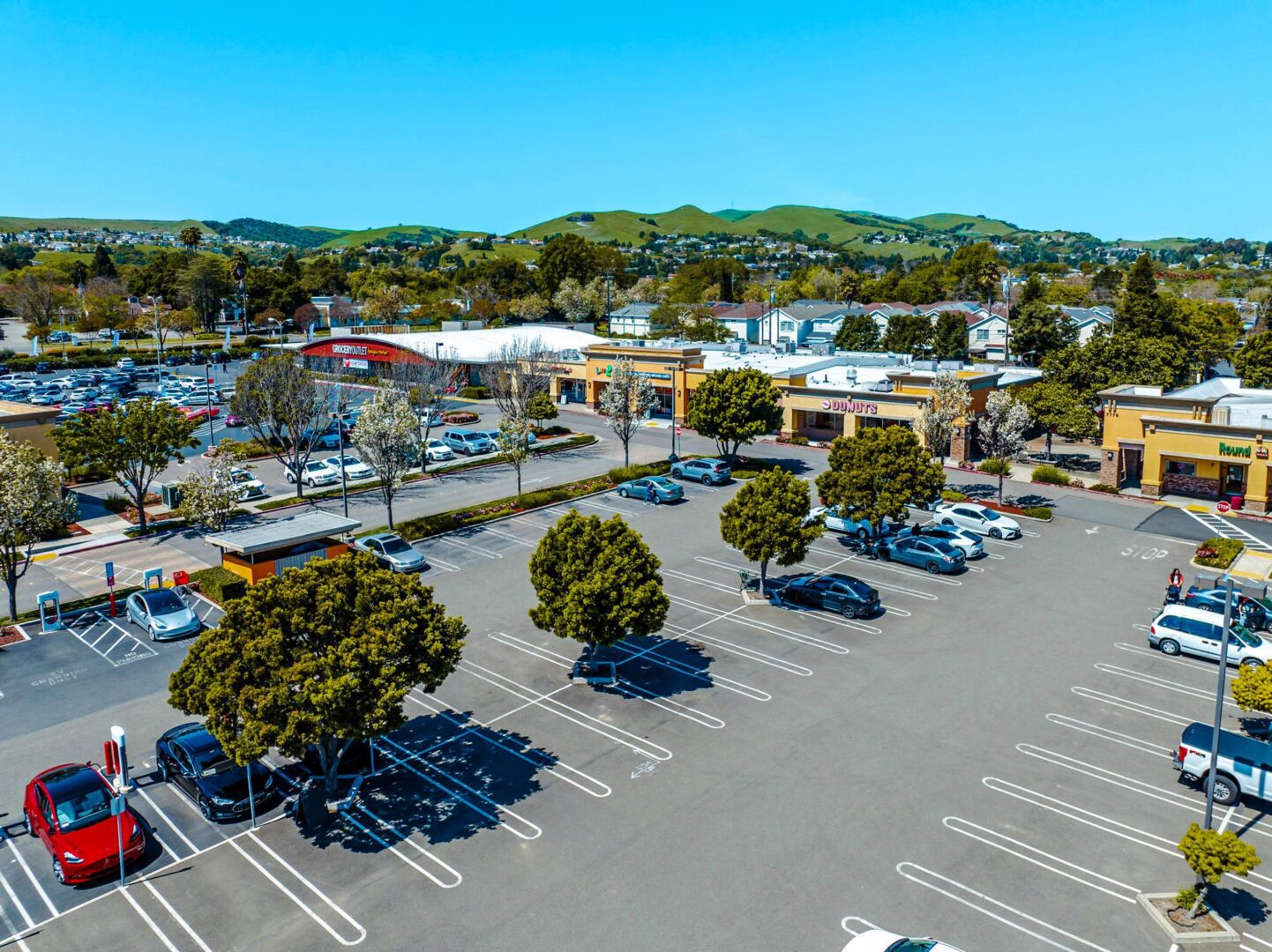 A parking lot with many cars parked in it