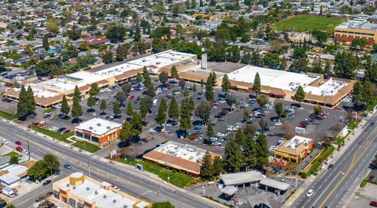 A large parking lot with many cars parked in it.